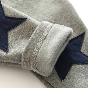 Close-up of grey toddler trousers with star patch and thick fleece lining for warmth