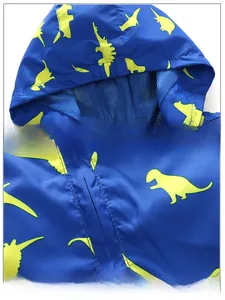 Detail of kids hooded jacket with breathable blue mesh lining and dinosaur print