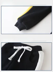 Detail of boys joggers showing elastic drawstring waist and ribbed cuffs with side stripes