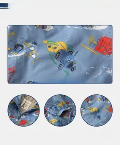 Detail of blue cartoon tractor print jacket with elastic cuffs and secure zipper