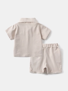 Back view of boys summer cotton polo shirt and shorts set in beige neutral tones