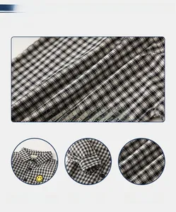 Detail of children's black and white checkered shirt fabric with yellow smiley embroidery