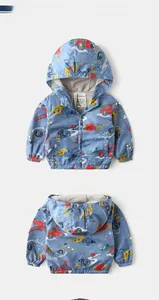 Front and back view of baby blue hooded windbreaker with colorful cartoon truck prints