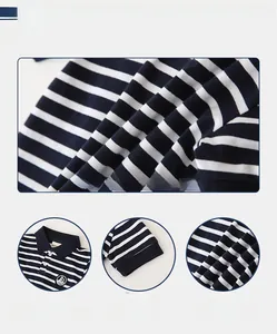 Detail of boys blue striped polo shirt featuring ribbed cuffs and sailboat embroidery