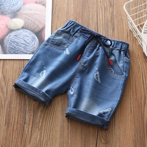 Dettaglio dei pantaloncini di jeans per bambini con elastico in vita e stampa di auto