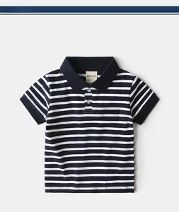 Detail of nautical sailboat embroidery on striped cotton polo shirt for boys