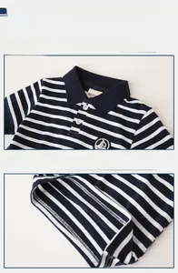 Detail of blue and white striped kids polo shirt featuring nautical embroidery and white buttons