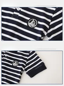 Detail of nautical sailboat embroidery and ribbed cuffs on striped cotton polo shirt
