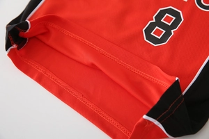 Detail of red mesh basketball jersey showing breathable fabric and black number 8 print