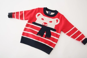 Close-up of kids red knit sweater featuring white cartoon bear and ribbed navy blue neck