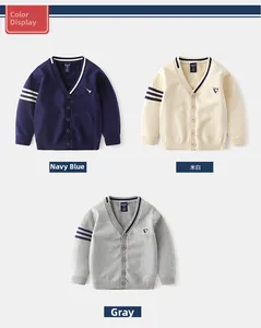Three children's knit cardigans in navy, white, and grey with striped sleeve details