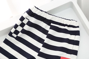 Close-up of boys' striped shorts featuring an elastic waistband and red side patch