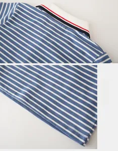 Detail of blue and white striped boys polo shirt showing collar and double-stitched hem