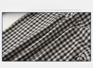 Close-up of soft black and white gingham cotton fabric texture for boys shirt