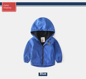 Dettaglio della toppa 'COOL PIRATE' e della cerniera sulla giacca blu con cappuccio