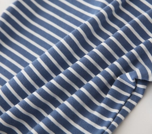 Close-up of soft blue and white striped knit fabric texture for boys polo shirt