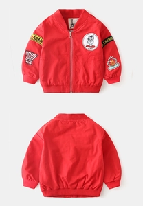 Detail showing red boy's bomber jacket with ribbed knit cuffs and army themed patches