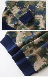 Detail of ribbed cuffs and hem on kids sweatshirt with colorful dinosaur camo print