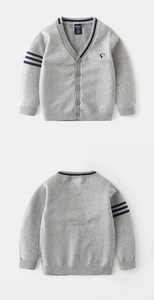 Detailed knit texture of a grey baby cardigan with penguin embroidery and blue stripes