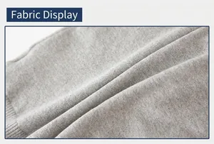Close-up of light gray knitted cotton fabric detail with visible ribbed cuffs craftsmanship