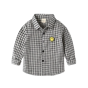 Classic black and white checkered long sleeve shirt for boys with a yellow smiley face patch
