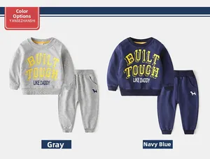 Detail of boys' two-piece sweatpants set with Built Tough Like Daddy print and dog embroidery