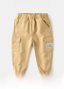 Detail of khaki kids cargo pants with elastic waistband and FIND HAPPINESS letter patch