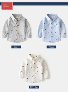 Detailed flat lay of boys' cotton shirts in grey, blue, and white with cartoon patterns