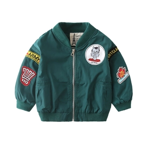 Boys dark green bomber jacket with casual zipper and stylish patches for autumn season