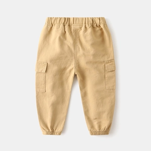 Detail of khaki cargo pants for boys with elastic waistband and large side flap pockets