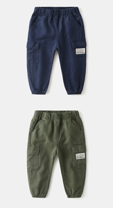 Detail of kids cargo pants with functional flap pockets and elastic waistband in twill cotton