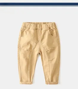 Detail of khaki boys' casual pants showing elastic waistband and stitching on pockets