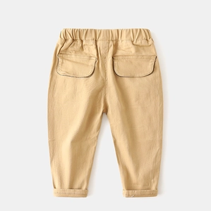 Detail of khaki cotton trousers for boys with elastic waistband and back pockets