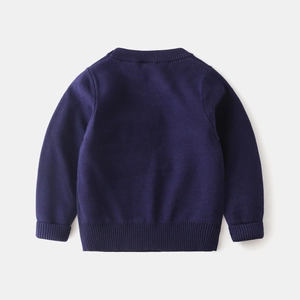 Detail view of children's navy blue knit sweater featuring ribbed cuffs and hem on flat lay