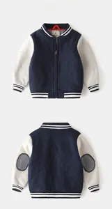 Detailed view of quilted navy body and grey sleeves on toddler boy's baseball jacket