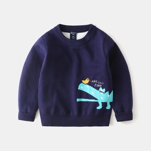 Detail of navy blue knit sweater featuring cartoon crocodile embroidery and brand label