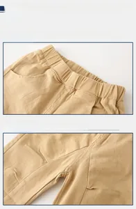 Detail view of khaki cotton boy pants showing elastic waistband and stitching