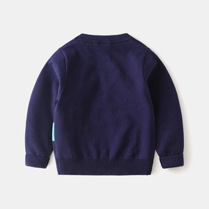 Detail of navy knit sweater back showing ribbed cuffs and soft texture on plain background