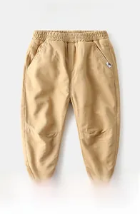 Macro view of children's fleece-lined trousers featuring elastic waistband and warm lining