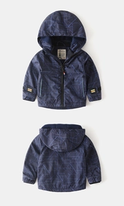 Detail of dark blue hooded boys' jacket featuring geometric patterns and adjustable cuffs
