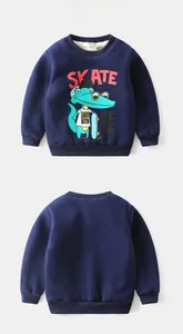 Flat lay of navy blue fleece sweatshirt for kids with green crocodile skating graphic
