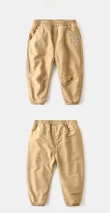 Detail of khaki kids winter joggers showing elastic waistband and animal fabric label