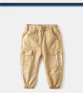 Detail of khaki kids cargo pants featuring elastic waist and utility pockets with white stripes