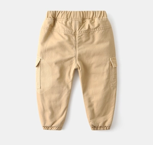 Detailed view of kids cargo pants showing elastic waistband and functional side flap pockets