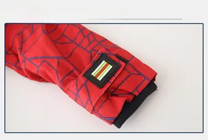 Detail of kids winter jacket cuff with velcro strap, stripe patch, and windproof ribbing