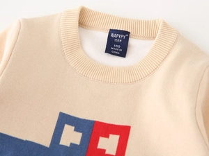 Close-up of boys' knitted sweater neckline with car-inspired geometric patterns