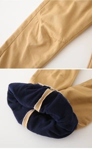 Detailed close-up of thickened fleece lining and reinforced knee patches on kids' winter pants