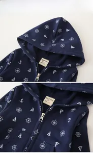 Detail of navy blue kids' hoodie with nautical anchor print and sturdy metal zipper