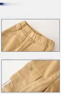 Detail view of elastic waistband and cargo pocket on khaki casual trousers for kids