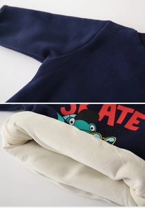 Detail of kids winter fleece sweatshirt showing soft thick lining and skate print